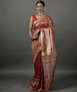 "Model wearing a stunning orange crushed tissue silk saree with elegant gold zari accents." By Mirra Clothing