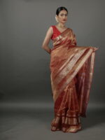 "Orange crushed tissue silk saree displayed flat, highlighting its rich color and luxurious gold detailing."By Mirra Clothing