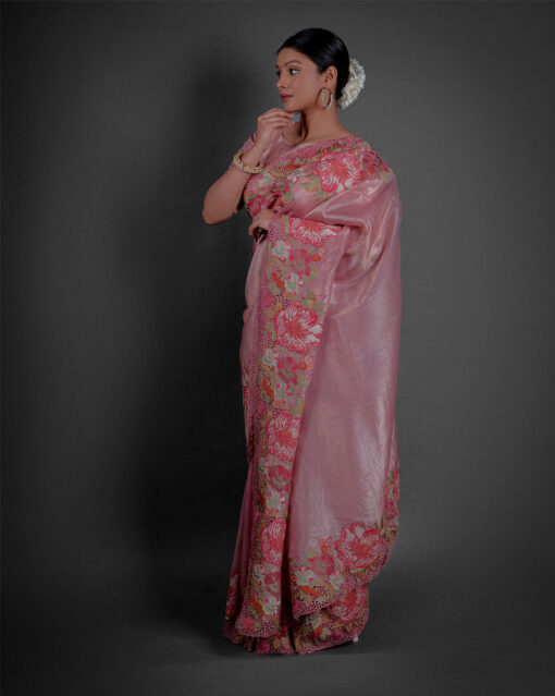 Side view of a model showcasing Pink Tissue Silk Saree with Cutwork Embroidery, Crafted for festive spirit By Mirra Clothing