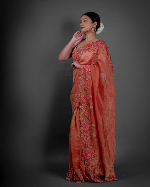 Side view of a model showcasing Red Crushed Tissue Silk Saree With Cutwork Embroidery, Ideal for occasions like engagements or baby showers By Mirra Clothing