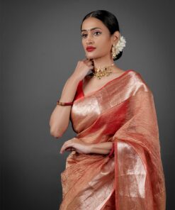 "Close-up of an orange crushed tissue silk saree, highlighting its unique crinkle effect."By Mirra Clothing