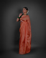 Side view of a model showcasing Orange Tissue Silk Saree , Ideal for festive occasions By Mirra Clothing