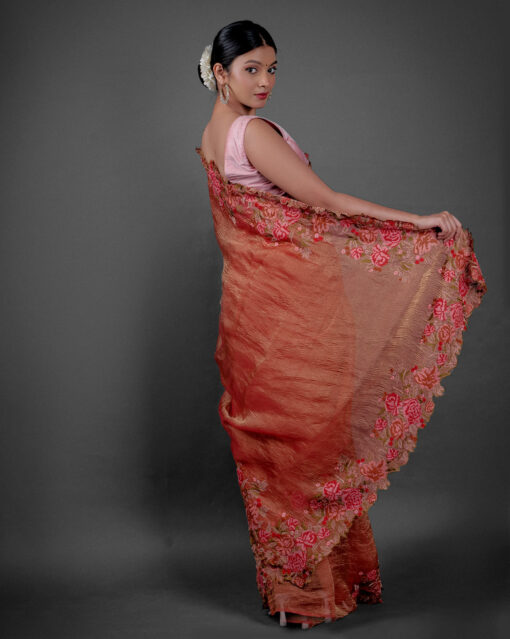 Back view of a model showcasing Red Crushed Tissue Silk Saree With Cutwork Embroidery, Perfect for celebrating achievements like promotions or graduations By Mirra Clothing