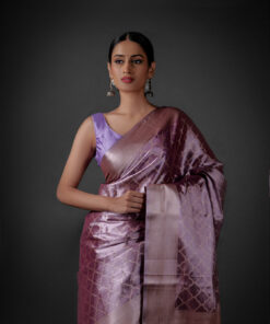 "Elegant lavender tissue silk saree featuring intricate zari weaves and delicate patterns."By Mirra Clothing