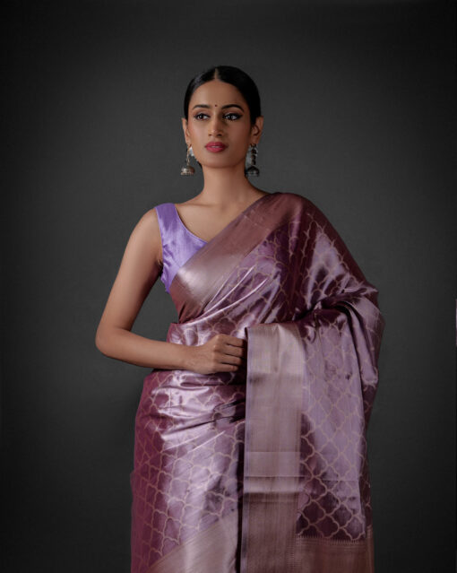 "Elegant lavender tissue silk saree featuring intricate zari weaves and delicate patterns."By Mirra Clothing