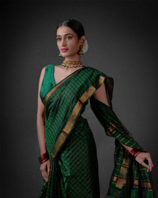 A model wearing a Bottle Green Mangalagiri silk saree by Mirra Clothing