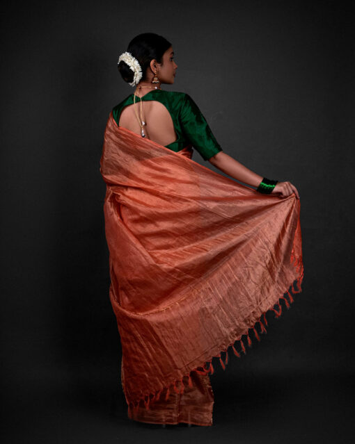 Back view of a model showcasing Orange Tissue Silk Saree , Excellent for festive gatherings By Mirra Clothing