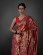 Close up view of a model showcasing Red Banarasi Silk Saree with Gold Zari Weaves , Suitable for Festive occasions By Mirra Clothing