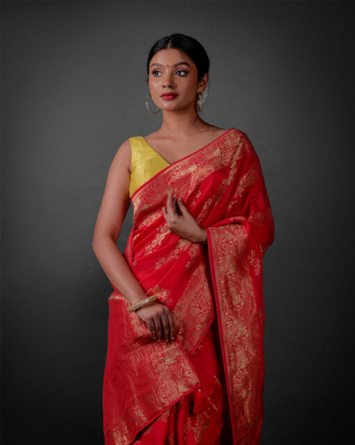 Front view of a model showcasing a Rani Pink Banarasi Georgette Saree With Gold Zari weaves , Perfect for birthdays or anniversaries within the family