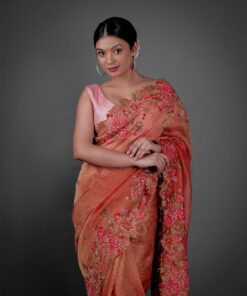 Front view of a model showcasing a Red Crushed Tissue Silk Saree With Cutwork Embroidery, Perfect for capturing special moments or portraits. By Mirra Clothing