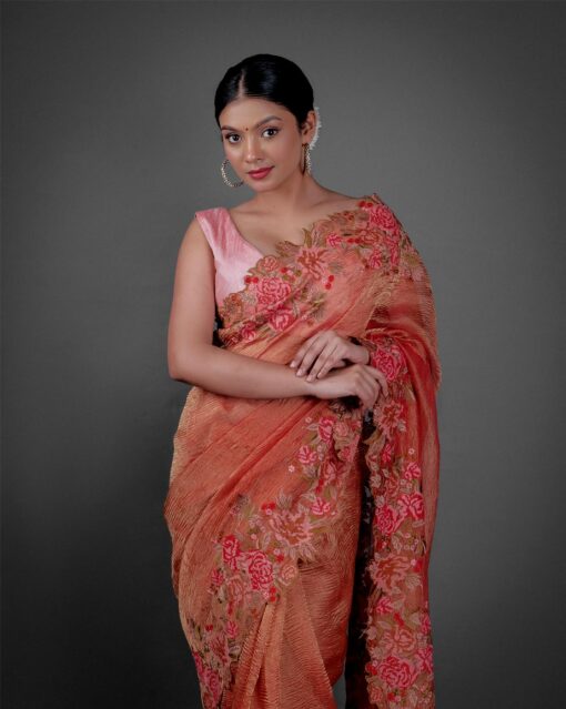 Front view of a model showcasing a Red Crushed Tissue Silk Saree With Cutwork Embroidery, Perfect for capturing special moments or portraits. By Mirra Clothing