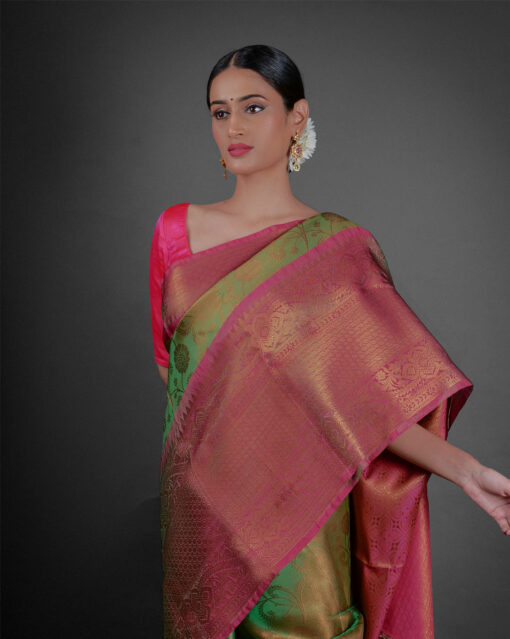 Close up view of a model showcasing Green Tissue Silk Saree With Contrast Border , Ideal for festivities By Mirra Clothing