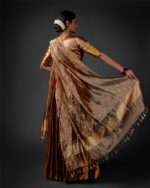 "Back view of a model showcasing Molten Gold Tissue Silk Half Saree Set with Dupatta and Blouse, Suitable for grand occasions "By Mirra Clothing