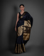 "A contemporary styling of a Black Banarasi saree, paired with a stylish off-shoulder blouse for a modern twist on traditional attire."by Mirra Clothing