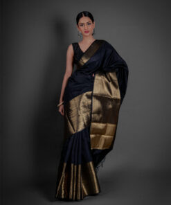 "A contemporary styling of a Black Banarasi saree, paired with a stylish off-shoulder blouse for a modern twist on traditional attire."by Mirra Clothing