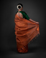 Back view of a model showcasing Copper Tissue Silk Saree with Self Design Border, Suitable for social events By Mirra Clothing