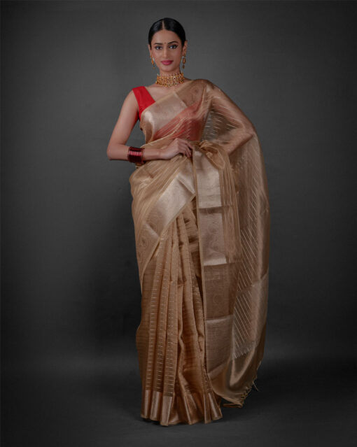 Full view of a model showcasing Ivory Tissue Silk Saree with Gold Zari Stripes, Adds a touch of sophistication to evening gatherings By Mirra Clothing