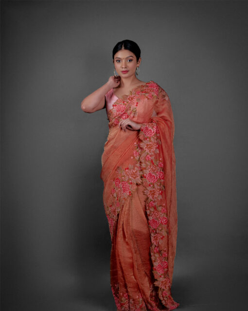 Full view of a model showcasing Red Crushed Tissue Silk Saree With Cutwork Embroidery, A lovely choice for pre-wedding celebrations By Mirra Clothing