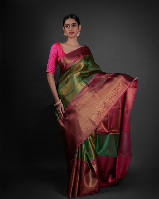 "Side view of a model showcasing Green Tissue Silk Saree With Contrast Border , Appropriate for festivities "By Mirra Clothing