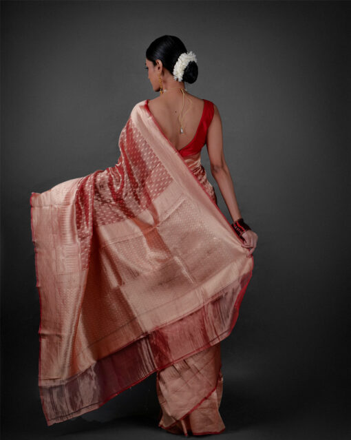 "Pallu of a lightweight tissue saree cascading gracefully, highlighting its luxurious texture."by Mirra Clothing