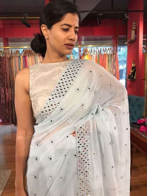 Front view of a model showcasing a Baby Blue Chiffon Silk Saree Embellished with Mirrors, An Excellent Option for Party Outfits By Mirra Clothing