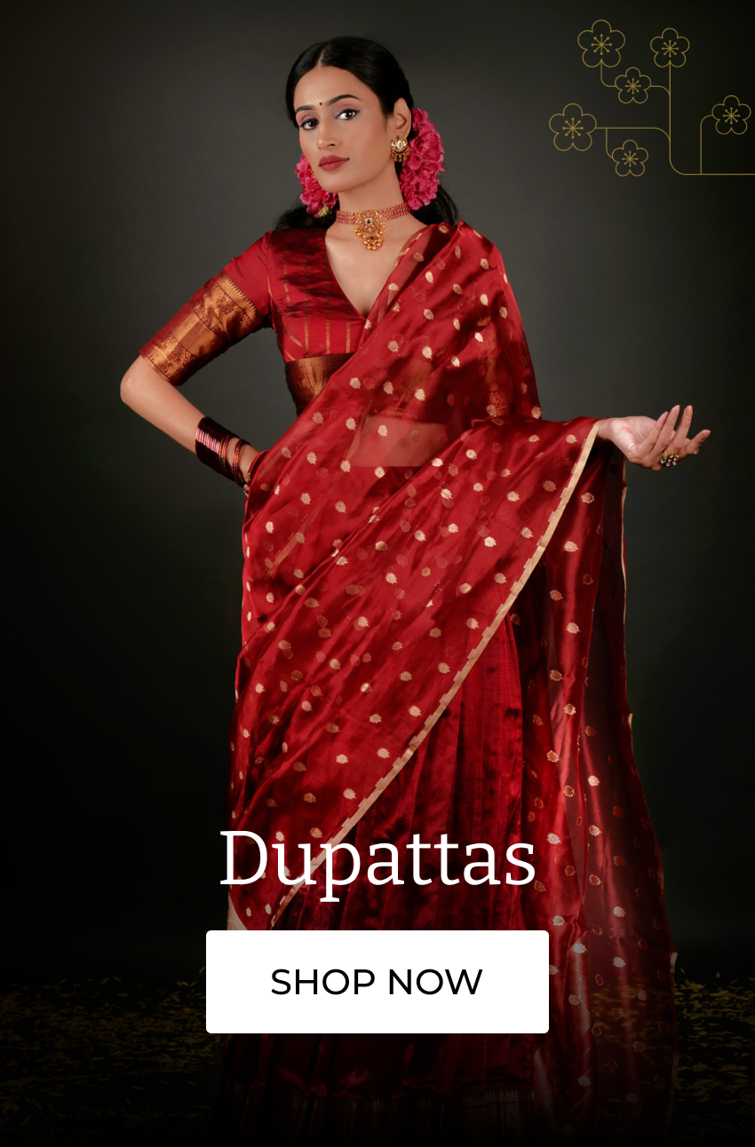 Woman draped in a luxurious red dupatta with golden polka dots, styled with traditional jewelry, ideal for festive occasions.