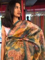 Close up view of a model showcasing Blue Printed Tissue Silk Saree, Suitable for traditional performances or fairs By Mirra Clothing