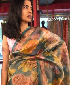 Close up view of a model showcasing Blue Printed Tissue Silk Saree, Suitable for traditional performances or fairs By Mirra Clothing