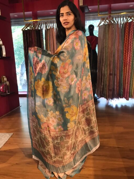 "Side view of a model showcasing Blue Printed Tissue Silk Saree, Ready for festive gatherings " By Mirra Clothing