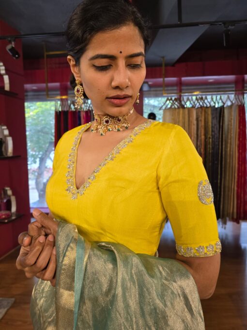 Side view of a model showcasing Lemon Yellow Silk Blouse, designed for elegance at any party. By Mirra Clothing