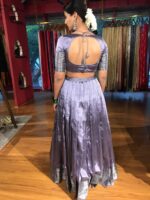 Side view of a model showcasing Lilac Silk Lehenga Set (Set of 2), Appropriate for major Hindu celebrations like Durga Puja and Navratri By Mirra Clothing