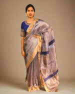 Side view of a model showcasing Blue Tissue Silk Saree, Suitable for festive occasions by Mirra Clothing